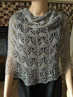 Silver lace hand knitted shawl with silver lined glass beads. Knitted with 100% silk yarn.  Approximately 75" from end to end and 24" at the widest point.  Great for any season and for any special occasion.  Pattern from Boo Knits. Can be worn in many different ways. The silk is a very breathable fiber and makes for a lovely drape! Lace Shawl Scarf For Weddings, Elegant Hand Knitted Shawl Scarf, Lace Wedding Scarf Shawl, Elegant Knitted Shawl Scarf, Elegant Hand-knitted Shawl Scarf, Elegant Handmade Scarves For Weddings, Elegant Crochet Shawl For Wedding, Lace Shawl Scarves For Wedding, Elegant Lace Shawl Scarf