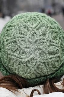 a woman wearing a green knitted hat on top of her head