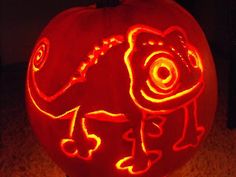 a carved pumpkin with an image of a lizard on it