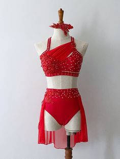 a woman's red and white bathing suit on a mannequin headdress