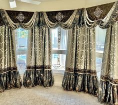 a large window with curtains and valances in front of the windows sill