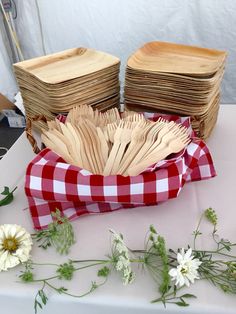 a table topped with lots of wooden utensils and flowers next to each other