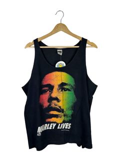 VINTAGE bob marley tank tee, graphic, museum, redemption song, lyrics, 90s, 1990s, single stitch, size Extra Large vintage BOB MARLEY tank tee by the Bob marley museum tank tee is in good condition, see photos for details.  size tag is a mens EXTRA LARGE, but can fit all sizes depending on the desired fit. flat measurements- pit to pit: shoulder to bottom hem:  sleeves measured from shoulder to cuff:  sleeves measured from pit to cuff:  materials- cotton 100% made in the usa 90s Letter Print Tank Top For Streetwear, Retro Graphic Print Tank Top For Streetwear, Graphic Print Cotton Tank Top For Music Festival, Cotton Graphic Print Tank Top For Music Festival, Cotton Tank Top With Graphic Print For Festivals, Cotton Graphic Print Tank Top For Festivals, Graphic Print Tank Top Band Merch For Streetwear, Retro Letter Print Tank Top For Streetwear, Band Merch Screen Print Tank Top For Streetwear