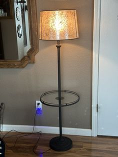 a lamp that is sitting on top of a table next to a mirror and light