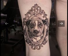 a black and white photo of a dog in a frame tattoo on the right thigh