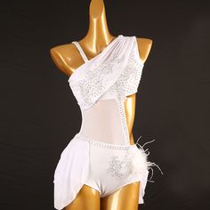 a mannequin wearing a white bodysuit with feathers on it