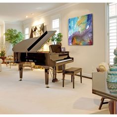 a living room filled with furniture and a grand piano