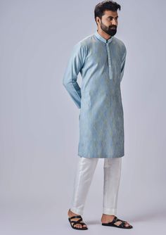 Editor's Note The light blue kurta with multicolor thread and pants is a vibrant and eye-catching ensemble. The kurta features a light blue color with intricate multicolor threadwork, adding a pop of color and texture to the overall design. It is complemented by matching pants, creating a coordinated and stylish look. Fabric: Cotton silk Color: Blue Components: Kurta and pants Occasion: Festive Note: Product colour may slightly vary due to photographic lighting sources Care: Dry clean only About Light Blue Straight Kurta Salwar Kameez, Designer Light Blue Straight Kurta Set, Festive Light Blue Straight Kurta Salwar Kameez, Festive Light Blue Dabka Salwar Kameez, Festive Light Blue Long Sleeve Lawn Suit, Light Blue Straight Kurta Salwar Kameez For Eid, Unstitched Light Blue Salwar Kameez With Long Sleeves, Light Blue Straight Kurta Sets For Festive, Unstitched Light Blue Long Sleeve Salwar Kameez