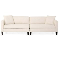 a white couch with two pillows on it