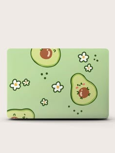 an avocado pattern with flowers and ladybugs on the green skin for the apple macbook air