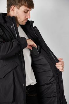 Stay warm this winter with the Men's Winter Hooded Parka Cargo Long Sleeve Coat. This stylish coat is crafted from durable material to provide protection against cold temperatures and is designed with a hood for added warmth. It features cargo pockets for storage and a drawstring waist for a customizable fit. This chic zip down jacket features removable faux-fur trim along the hood so you can wear it as needed to keep you comfortable and cozy. The winter jacket features adjustable sleeve opening Hooded Outerwear For Winter Sports With Double-lined Hood, Windproof Winter Outerwear For Cold Weather, Windproof Outerwear For Cold Weather, Winter Down Outerwear For Outdoor, Winter Outdoor Down Outerwear, Waterproof Winter Outerwear For Cold Weather, Winter Outerwear With Double-lined Hood For Outdoor Activities, Winter Outdoor Outerwear With Detachable Hood, Winter Nylon Outerwear With Pockets