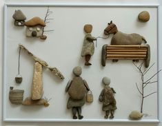 an arrangement of rocks and toys displayed in a white frame