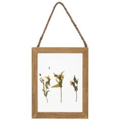 a wooden frame hanging on a rope with flowers in it