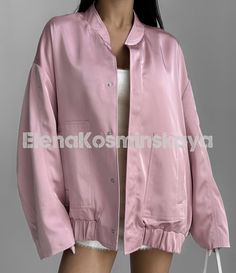 Pink satin oversized bomber jacket is a stylish choice for any occasion!  Our bomber jacket with lined, has large patch pockets, and fastens with buttons at the front.  The jacket is universal and can be worn both casually for every day, combining with various styles of clothing, and for special occasions, complementing a holiday suit or evening dress.   DETAILS  - pink  - satin  - lined  - button closure  - oversized  - large front patch pockets   SIZES   This bomber jacket is oversized  Back length 29.13"/ 74 cm Shoulder 8.26"/ 21 cm Sleeve length 21.25"/ 54 cm   More selection of suits and other clothes here https://www.etsy.com/uk/shop/ElenaKosminskaya SHIPPING Standard shipping (14-30 days) is FREE for you. Worldwide. Any country.  If you want to have express shipping, please, upgrade Drop Shoulder Jacket, Holiday Suits, Shoulder Jacket, Jacket For Women, Oversized Jacket, Line Jackets, Pink Satin, Dress Details, Quality Clothing