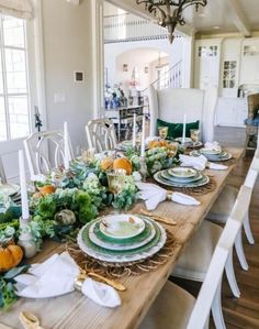 the table is set with plates and place settings