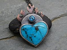 Flaming Heart Pendant Turquoise Heart Pendant, Flaming Sacred Heart Pendant Mixed Metal, Turquoise Mountain Heart Necklace, Gift For Her// Big flaming heart pendant with a stunning Turquoise gemstone.// Awesome as a gift for men and women alike, and also to keep for yourself.// Turquoise is a December birthstone. Also a great gift for your 6th and 11th anniversary.> pendant overall hanging length is 37mm (1.45 inches) > Turquoise mountain Turquoise and blue Topaz gemstones> hand made fr Turquoise Spiritual Jewelry For Anniversary, Spiritual Turquoise Jewelry For Anniversary, One Of A Kind Heart Jewelry For Anniversary, Artisan Heart-shaped Gemstone Jewelry, Artisan Jewelry With Heart Charm For Valentine's Day, Artisan Heart Charm Jewelry For Valentine's Day, Spiritual Blue Jewelry With Heart Charm, Artisan Pendant Jewelry For Valentine's Day, Turquoise Heart Pendant Necklace