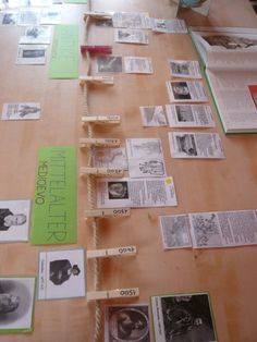 the table is covered with books and papers that have been placed on top of each other