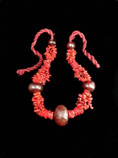 This is an exceptionally rare necklace, crafted from natural red coral beads, carefully separated by beads made from resin extracted from fossilized tree sap. These unique materials are sourced from the southern regions of Morocco, making this necklace a true treasure for those who appreciate authentic and rare jewelry. Please be aware that due to the handmade nature of the items, there might be slight variations in measurements and color. Your understanding is greatly appreciated. Note: Please provide a phone number for a smoother, faster, and safer delivery. You can add this information during checkout or send it to us via direct message. the craftsman's work is never perfect but it remains unique Bohemian Red Coral And Wooden Beads, Bohemian Polished Red Coral Beads, Bohemian Red Coral Polished Beads, Traditional Handmade Red Coral Beads, Bohemian Red Coral Beads For Jewelry Making, Red Coral Jewelry With Wooden Beads, Red Coral Necklace With Wooden Beads, Handmade Bohemian Red Coral Beads, Traditional Red Coral Jewelry With Wooden Beads