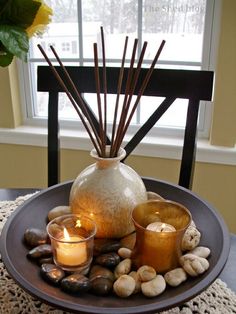 a plate with candles and rocks on it