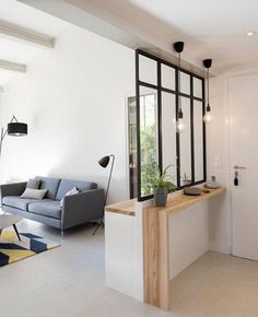 a living room filled with furniture next to a window