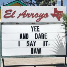 a sign that says el arrogo yee and dare i say it, haw