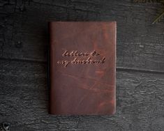 a brown leather journal with the words, letters to my husband written in cursive writing