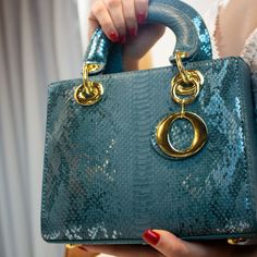 The Amina Teal Handbag goes with literally everything. From Jeans, Office wear, dinner wear, evening gowns, cocktail dress, you name it. The square shaped bag with its gold key chain embellishment to elevate that outfit. Name the occasion, Brunch? Date Night? Weddings? Business Conferences? Casual Events?. Tons of ways to style the AMINA Handbags. Product Details Tote Bag Metal lock detail Key chain Removable adjustable shoulder strap Inner compartment Gold handle design Satin Inner lining Measu Elegant Shoulder Bag With Chain Strap As Gift, Luxury Evening Bag With Top Handle For Events, Luxury Top Handle Evening Bag For Events, Luxury Box Bag With Chain Strap For Evening, Chic Party Box Bag, Luxury Square Evening Bag With Detachable Handle For Party, Luxury Square Evening Bag With Detachable Handle, Luxury Evening Bag With Handle Drop, Square Evening Bag With Detachable Handle For Party