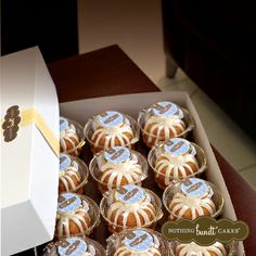 a box filled with cupcakes sitting on top of a table