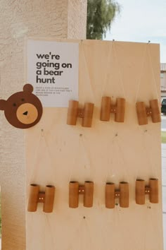 there is a sign that says we're going on the bear hunt with wooden pegs attached to it