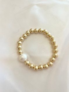 This gold ball and freshwater pearl bracelet is the perfect staple piece for your bracelet stack. Made with 18k gold filled 7mm gold balls and a 8mm freshwater pearl, this bracelet will be your perfect statement piece! Wear alone or pair with your Prata bracelet for a chunky layered look. Freshwater Pearl Bracelet, Layered Look, Staple Pieces, Bracelet Stack, Pearl Bracelet, Statement Pieces, Freshwater Pearls, Gold Filled, 18k Gold