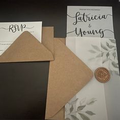 the wedding stationery is laid out on top of each other, including a wax stamp