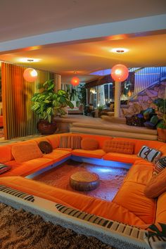 an orange couch in the middle of a living room