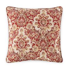 a red and beige pillow with an ornate pattern on the front, sitting on a white background