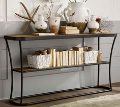 a shelf with books and vases on it