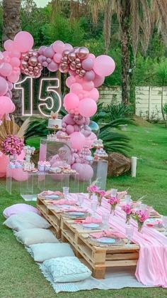 the table is set up with pink balloons