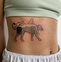 a woman with a tattoo on her stomach has a cheetah and yoga pose