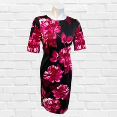 This Cerise and Black Floral Dress is tailored to perfection, creating a shift dress that is both elegant and classy. Unique fashion, designed with a women's fashion boutique in mind, makes this dress stand out from the pack. Classic Tailored Elegant Shift Dress, featuring around neck , 3/4 sleeve and back zip. You can not go wrong with this one. Fabric 95% Polyester / 5% Spandex Dry Clean Elegant Floral Print Midi Dress For Work, Fitted Floral Print Office Dresses, Elegant Fitted Floral Print Bodycon Dress, Elegant Floral Print Bodycon Dress For Evening, Elegant Sheath Midi Dress With Floral Print, Elegant Evening Bodycon Dress With Floral Print, Formal Floral Print Dressy Dresses, Elegant Shift Mini Dress Knee-length, Floral Print Fitted Formal Dress