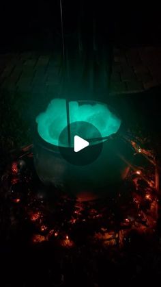 a glowing bowl in the dark with a green light on it