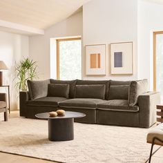 a living room filled with furniture and a large rug on top of a hard wood floor