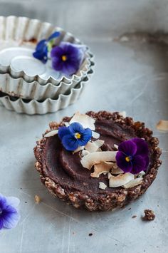 there are two pies with flowers on top of them and one has blue pansies