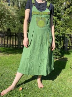 "Our skirt dungarees are handmade from handwoven organic nepalese  100% cotton.  -100% Cotton -Handmade in Nepal -2 Side Pockets -1 Front pocket - Adjustable straps -3 side button closure The side pockets are very deep and comfortable, a big plus! SIZES: S/M waist       92 cm length    125 cm L/XL waist       98 cm length   130 cm The cotton is not very heavy.  PLEASE CHECK ALL OTHER COLOR OPTIONS WE HAVE IN OUR SHOP. Dungarees are thought to have been named after Dongari Kapar, a harbourside village near Mumbai in India where a coarse, thick calico was manufactured. The Hindi name for this cloth was \"dungri\". Gradually \"dungaree\" transferred from the name of the cloth to denote instead the style of the overalls - a pair of trousers held up with a bib and shoulder straps. \"If you like Cotton Overalls With Tie Straps, Cotton Sleeveless Overalls With Tie Straps, Sleeveless Cotton Overalls With Tie Straps, Cotton Sleeveless Pinafore Dress With Adjustable Straps, Sleeveless Cotton Suspender Dress With Pockets, Green Cotton Dress With Adjustable Straps, Green Cotton Dresses With Adjustable Straps, Green Cotton Sundress With Adjustable Straps, Green Bohemian Sundress With Adjustable Straps