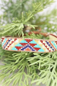 Introducing our adjustable southwestern beaded cuff bracelets! This colorful cuff bracelet is handmade with a southwestern-inspired pattern in cream, dark red, blue, orange, turquoise, and soft yellow.The bracelet is strung on strong beading thread and flexible leather cord with an adjustable closure, making it easy to put on and take off, while also allowing you to customize your fit. It will fit 6-8 inch wrists.Whether you're dressing up for a special occasion or just accenting your everyday s Beading Thread, Orange Turquoise, Beaded Cuff Bracelet, Bead Weaving Patterns, Beaded Cuff, Soft Yellow, Weaving Patterns, Blue Bracelet, Bead Weaving