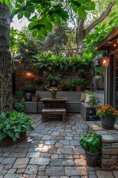 an outdoor patio with potted plants and lights on the ceiling, surrounded by brick pavers