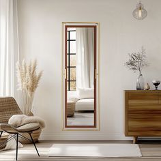 a white room with a mirror and chair