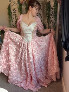 The Elain gown inspired from the Acotar series.  Made with satin rosette fabric and a satin and brocade bodice. Also has a corset back for size inclusivity.  Size measurements are as follows: Small: height: 5'7"  bust: 34" waist: 30" Medium: height: 5'7" bust: 38" waist: 34" Large: height: 5'7" bust: 42" waist: 37" XL: height:  5'7" bust: 48" waist: 42" Princess Ball Gown With Corset Back For Debutante Ball, Princess Dress With Boned Bodice And Sweetheart Neckline, Princess Style Dress With Sweetheart Neckline And Boned Bodice, Princess Dress With Sweetheart Neckline And Boned Bodice, Quinceanera Gown With Boned Bodice Ball Gown, Princess Style Satin Dress With Fitted Bodice, Princess Style Satin Ball Gown, Fitted Princesscore Prom Dress, Fitted Ball Gown With Boned Bodice For Quinceanera