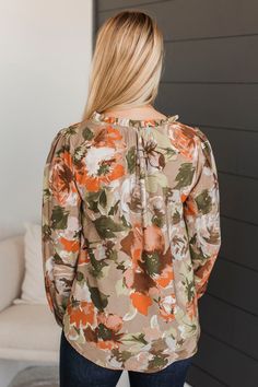 Fit & Details: Slightly relaxed with no stretch. Lightweight material with floral print Hi-low body style Notched neckline with ruffle trim Long puff sleeves with cinched cuffs Measurements: Small: Bust 38“ Back Length 26.5“ Medium: Bust 40“ Back Length 27“ Large: Bust 42“ Back Length 27.5“ Fabric & Material Care: Machine wash cold with like colors. Tumble dry low. 83% Rayon, 17% Nylon. *Made in the U.S.A* Model Info: Britta is modeling a small. Leah is modeling a large. Casual Billowy Blouse With Floral Print, Spring Long Sleeve Top With Gathered Neckline, Fall Floral Print Blouse For Brunch, Floral Print Blouse For Fall Brunch, Fall Brunch Floral Print Blouse, Casual Blouse With Floral Print And Ruffled Collar, Fall Floral Print Ruffle Sleeve Tops, Fall Floral Print Blouse With Ruffled Collar, Floral Print Balloon Sleeve Tops For Fall