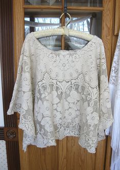 Beige vintage cotton lace is repurposed to create a one of a kind loose and flowey top to be worn over a camisole with jeans, capris, or long skirt. Fits up to a size L. The neck opening is 13 inches across. The bust measures 23 inches across lying flat. Machine wash gentle, tumble dry. As with all vintage materials, there may be a small snag or flaw. Browse more of my upcycled fashions at https://www.etsy.com/shop/LilyWhitepad?ref=hdr_shop_menu Long Skirt Fits, Granny Chic Fashion, Beige Lace Top, Festival Clothes, Summer Tunic, Upcycle Clothes Diy, Angel Sleeves, Romantic Summer, Summer Tunics