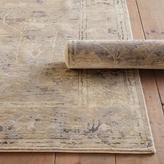 an old rug is laying on the floor next to a roll of carpeting material