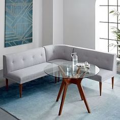 a living room with a glass table and couch