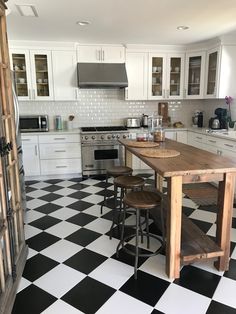 a kitchen with black and white checkered flooring